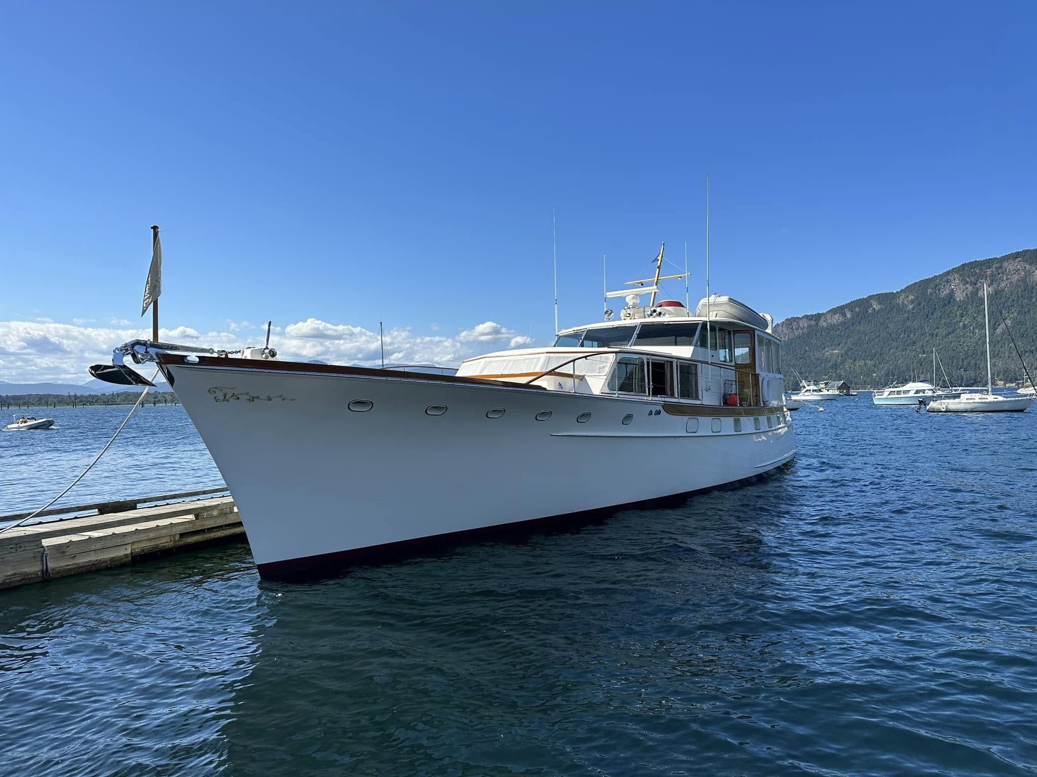 Classic 70-foot Trumpy yacht anchored at the dock during a multi-month restoration where the KS100 dust collector hood kept all sanding dust contained
